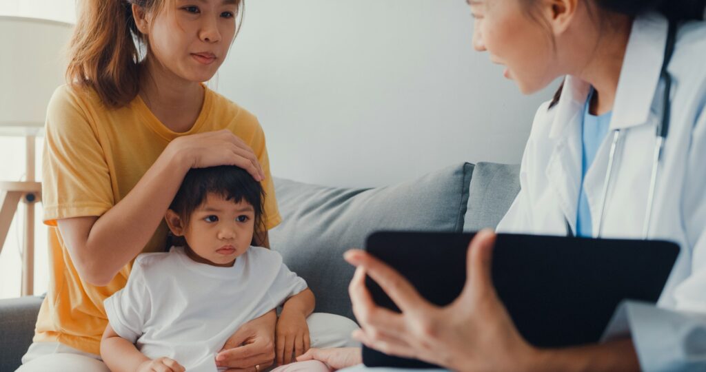 Paediatrician with child patient